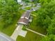An aerial of a two-story home with mature trees, a long driveway, and nice backyard in a suburban neighborhood at 15203 Shoreway Ct, Carmel, IN 46032
