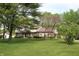 Charming two-story home with brick and siding exterior, mature trees, and a well-manicured lawn at 15203 Shoreway Ct, Carmel, IN 46032