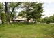 Spacious front yard with mature trees framing a two-story home featuring a brick and siding facade at 15203 Shoreway Ct, Carmel, IN 46032