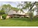 Two-story home with brick and siding exterior, surrounded by a lush green lawn and mature trees at 15203 Shoreway Ct, Carmel, IN 46032