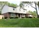 Attractive two-story home with brick accents and manicured shrubs lining the front, set against a vibrant green lawn at 15203 Shoreway Ct, Carmel, IN 46032