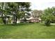 Landscaped front yard with mature trees highlighting a two-story home featuring a brick and siding exterior at 15203 Shoreway Ct, Carmel, IN 46032