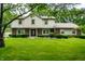 Traditional two-story home boasts a lush green lawn, mature trees and manicured bushes at 15203 Shoreway Ct, Carmel, IN 46032