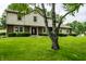 Traditional two-story home with manicured front lawn, trimmed bushes, and mature trees at 15203 Shoreway Ct, Carmel, IN 46032