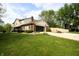 Spacious driveway leading to a two-car garage, featuring a well-manicured lawn and mature trees at 15203 Shoreway Ct, Carmel, IN 46032