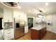 Modern kitchen featuring stainless steel appliances, white cabinets, an island, and open concept at 15203 Shoreway Ct, Carmel, IN 46032
