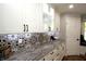 Bright kitchen features white cabinetry, mosaic backsplash, granite countertops and stainless steel appliances at 15203 Shoreway Ct, Carmel, IN 46032