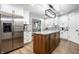 Open concept kitchen with stainless steel appliances, wood island, and white cabinetry at 15203 Shoreway Ct, Carmel, IN 46032