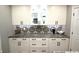 Beautiful kitchen with white cabinets, black hardware, mosaic backsplash and granite countertops at 15203 Shoreway Ct, Carmel, IN 46032