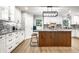 Well-designed kitchen with island, white cabinetry, and decorative tile backsplash at 15203 Shoreway Ct, Carmel, IN 46032