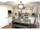 A kitchen and dining area with granite countertops, pendant lighting, and modern cabinetry at 15203 Shoreway Ct, Carmel, IN 46032