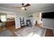 A living room with a ceiling fan, neutral walls, and views into the kitchen at 15203 Shoreway Ct, Carmel, IN 46032