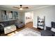 A comfortable living room features stylish decor, a ceiling fan, and views into the kitchen at 15203 Shoreway Ct, Carmel, IN 46032