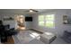 A cozy living room features a ceiling fan, neutral walls, and abundant natural light at 15203 Shoreway Ct, Carmel, IN 46032