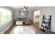 Cozy living room featuring a gray sectional, ceiling fan, and doorway to kitchen with decorative tile backsplash at 15203 Shoreway Ct, Carmel, IN 46032