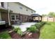 Inviting patio area with seating, a grill, and garden beds, perfect for outdoor dining and relaxation at 15203 Shoreway Ct, Carmel, IN 46032