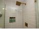Modern shower with sleek tile, niche storage, and high-end fixtures at 15203 Shoreway Ct, Carmel, IN 46032
