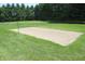 Outdoor sand volleyball court surrounded by lush green trees, perfect for recreational fun at 15203 Shoreway Ct, Carmel, IN 46032