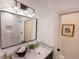 Modern bathroom vanity with marble countertop, gold faucet, decorative mirror and geometrically-tiled walk-in shower at 1525 Marlowe Ave, Indianapolis, IN 46201