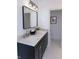 Modern bathroom featuring double vanity, black cabinets, and stylish lighting at 1525 Marlowe Ave, Indianapolis, IN 46201