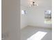 Empty bedroom featuring windows, carpeted floors, white walls and modern ceiling light at 1525 Marlowe Ave, Indianapolis, IN 46201