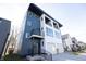 Modern two-story home featuring a two-car garage, black trim, and a mix of blue and white siding at 1525 Marlowe Ave, Indianapolis, IN 46201