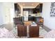 Stylish open-concept living area featuring a modern kitchen with black cabinets and seating at 1525 Marlowe Ave, Indianapolis, IN 46201