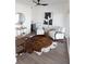 Bright sitting room with fur chairs, hardwood floors, modern art, and a ceiling fan at 1525 Marlowe Ave, Indianapolis, IN 46201