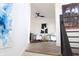 A cozy sitting area with white chairs, a modern ceiling fan, and unique artwork at 1525 Marlowe Ave, Indianapolis, IN 46201