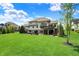 Backyard with a well-maintained lawn, hot tub, deck, and patio seating area, perfect for relaxation at 16731 George Gang Blvd, Westfield, IN 46062