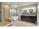 Modern bathroom featuring a walk-in shower, soaking tub, and dual vanity sinks at 16731 George Gang Blvd, Westfield, IN 46062