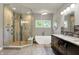 Bright bathroom featuring a luxurious soaking tub, a glass enclosed shower, and a double sink vanity at 16731 George Gang Blvd, Westfield, IN 46062