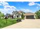 Charming home exterior with a well-manicured lawn, mature trees, and a paved driveway leading to the garage at 16731 George Gang Blvd, Westfield, IN 46062
