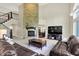 Spacious living room with a stone fireplace, tall ceilings, and ample natural light at 16731 George Gang Blvd, Westfield, IN 46062