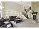 Cozy living room with a stone fireplace, staircase, and comfortable seating at 16731 George Gang Blvd, Westfield, IN 46062