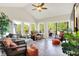 Bright sunroom with large windows, comfortable seating, and a view to the deck and outdoors at 16731 George Gang Blvd, Westfield, IN 46062