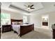 Well-lit main bedroom with a tray ceiling, neutral decor, and access to ensuite bath at 16731 George Gang Blvd, Westfield, IN 46062