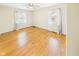 Spacious bedroom with hardwood floors, natural light, and ceiling fan at 1813 Kingsley Dr, Anderson, IN 46011