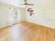 Bedroom with hardwood floors, ceiling fan, window with sheer curtains, and Africa wall art at 1813 Kingsley Dr, Anderson, IN 46011