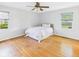 Calm bedroom featuring hardwood floors, white bedding and two windows at 1813 Kingsley Dr, Anderson, IN 46011