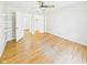 Bedroom showcasing hardwood floors, closet, ceiling fan, and doorways leading to other rooms at 1813 Kingsley Dr, Anderson, IN 46011