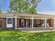 Charming brick home with a welcoming covered front porch and comfortable seating area at 1813 Kingsley Dr, Anderson, IN 46011