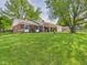 Expansive front lawn of the brick home with mature shade trees at 1813 Kingsley Dr, Anderson, IN 46011