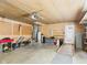 Organized garage with tools, lawn equipment, shelves, and a ramp for accessibility at 1813 Kingsley Dr, Anderson, IN 46011