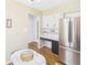 Bright eat-in kitchen with stainless steel refrigerator and black and white cabinets at 1813 Kingsley Dr, Anderson, IN 46011