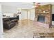 Comfortable living room with brick fireplace, ceiling fan and access to the kitchen at 1813 Kingsley Dr, Anderson, IN 46011