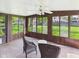 Relaxing sunroom with tile floor and multiple windows overlooking the backyard at 1813 Kingsley Dr, Anderson, IN 46011