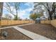 Large backyard featuring new wooden fence, storage shed, walkway, and ample space for landscaping at 1921 N Dexter St, Indianapolis, IN 46202