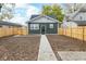 Home backyard featuring a new fence and a freshly prepared dirt area, ideal for custom landscaping at 1921 N Dexter St, Indianapolis, IN 46202