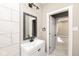 Bathroom with white vanity, modern fixtures, decorative mirror, and tile backsplash at 1921 N Dexter St, Indianapolis, IN 46202